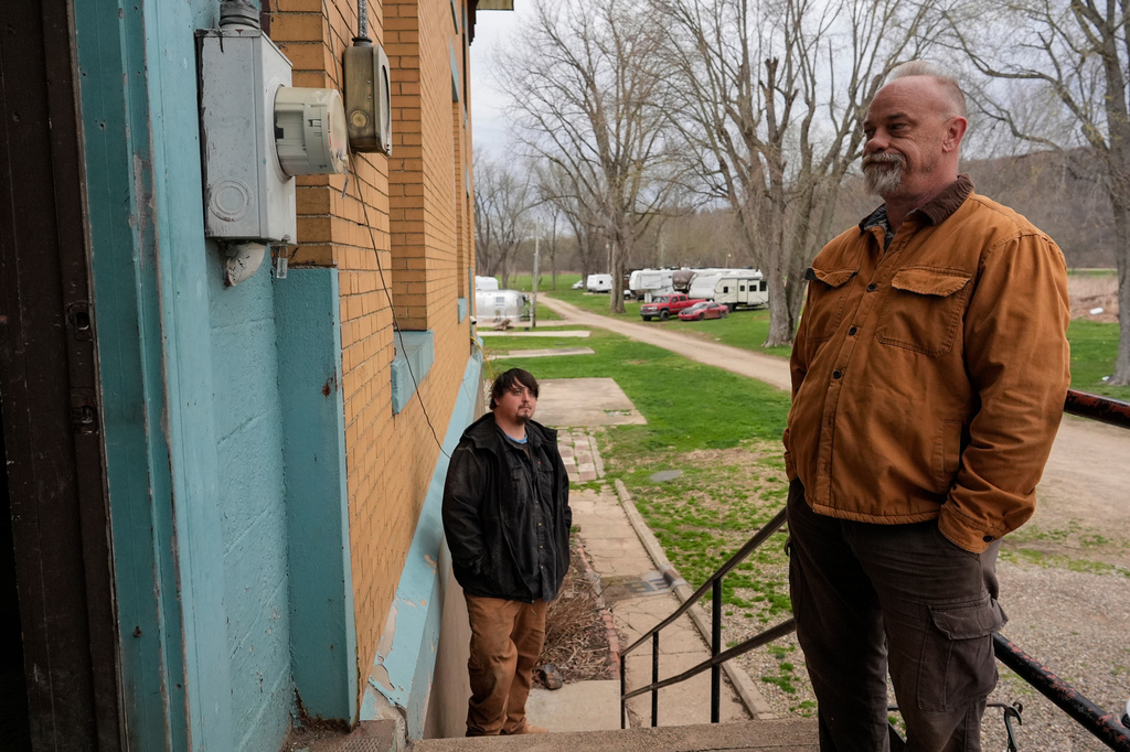 Eric Pinson, right, manager and resident of the Lock 24 RV Park and Campground, is joined by tenant John White Jr., as he looks at an electric meter on the campground in Racine, Ohio, Friday, March 13, 2026. (AP Photo/Carolyn Kaster)
