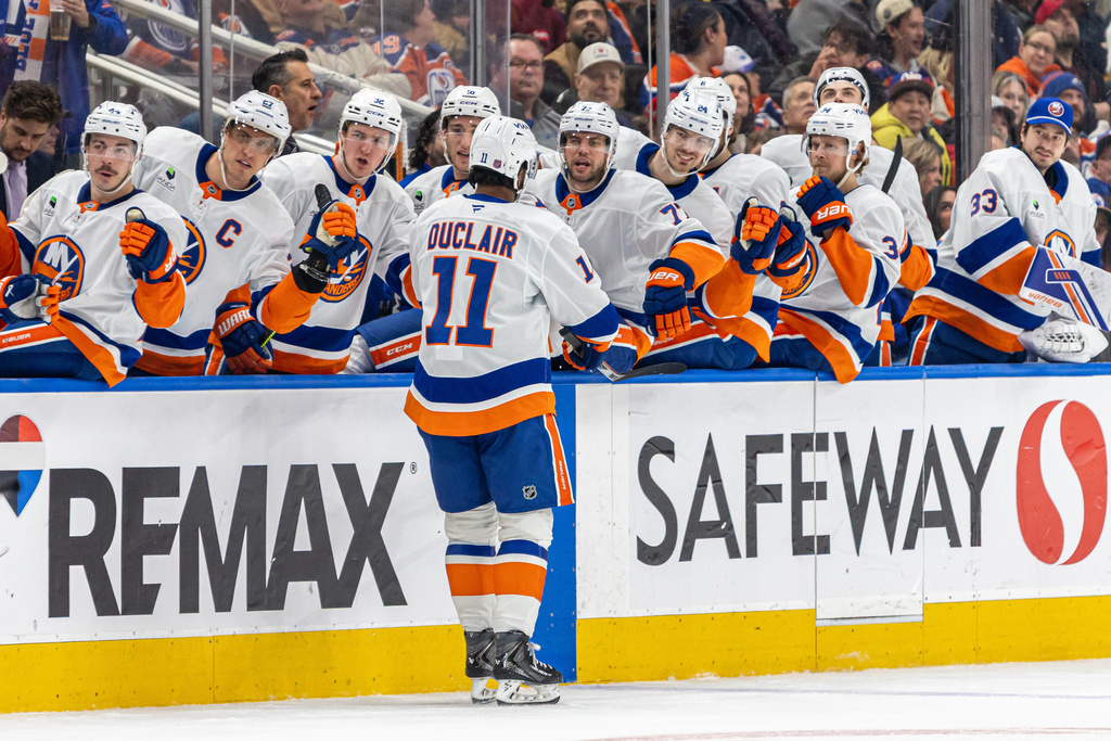New York Islanders' Anthony Duclair (11) celebrates with his teammates at the bench after a goal against the Edmonton Oilers during the third period of an NHL hockey game in Edmonton, Alberta, Thursday, Jan. 15, 2026. (Timothy Matwey/The Canadian Press via AP)
