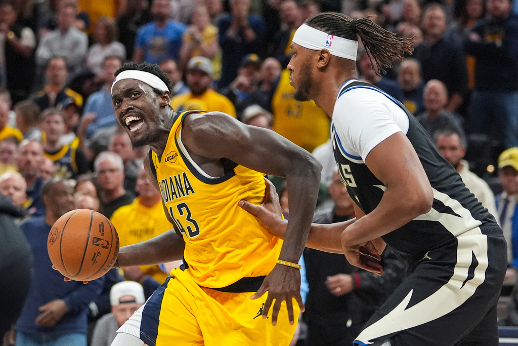 Indiana Pacers forward Pascal Siakam (43) drives on Milwaukee Bucks center/forward Myles Turner (3) during the second half of an NBA basketball game in Indianapolis, Monday, Nov. 3, 2025. (AP Photo/Michael Conroy)