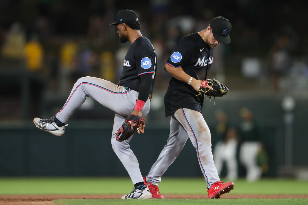 Miami Marlins' Otto Lopez, left, and Jakob Marsee, right, celebrate the Miami Marlins win over the Athletics in a baseball game Friday, July 3, 2026, in West Sacramento, Calif. (AP Photo/Scott Marshall)