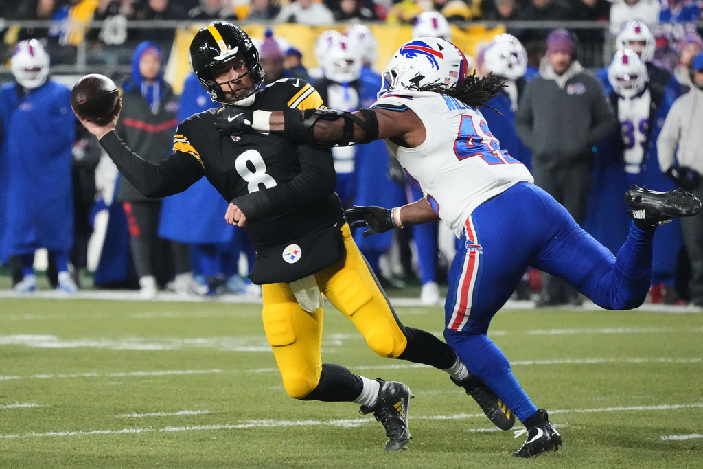 Pittsburgh Steelers quarterback Aaron Rodgers (8) throws against Buffalo Bills linebacker Dorian Williams (42) during the first half of an NFL football game Sunday, Nov. 30, 2025, in Pittsburgh. (AP Photo/Gene J. Puskar)