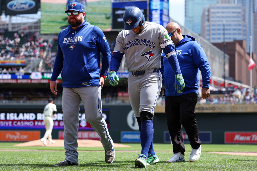 Toronto Blue Jays designated hitter George Springer walks off the field after getting hit by a pitch during the third inning of a baseball game against the Minnesota Twins, Saturday, May 2, 2026, in Minneapolis. (AP Photo/Matt Krohn)