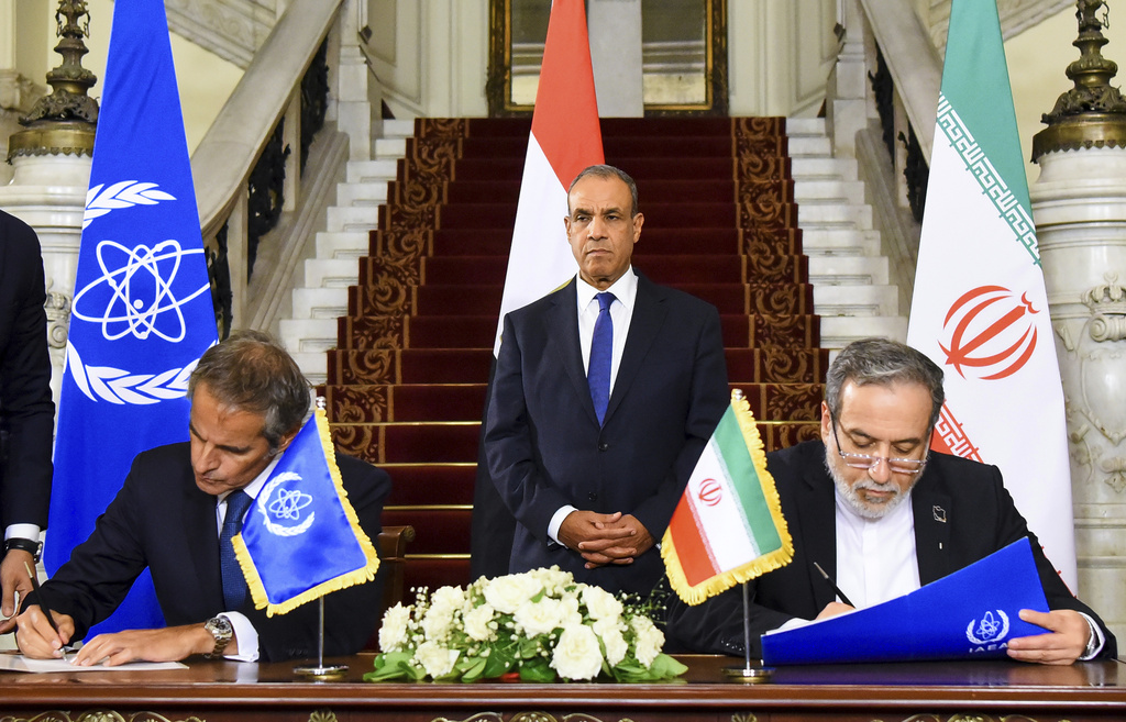 In this handout photo released by Egyptian Foreign Ministry Press Service, Iranian Foreign Minister Abbas Araghchi, right, and Director General of the International Atomic Energy Agency (IAEA) Rafael Grossi, left, an sign an agreement to open the way for resuming cooperation, at Tahrir Palace in Cairo, Egypt, Tuesday, Sept. 9, 2025. (Egyptian Foreign Ministry Press Service via AP)