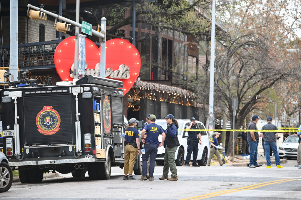 The Austin Police Department and the FBI investigate a shooting at Buford's on 6th Street on Sunday, March 1, 2026, in Austin, Texas. (AP Photo/Jack Myer)