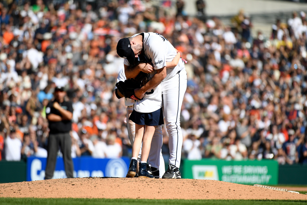 Genevieve Verlander, left, hugs her dad, Detroit Tigers starting pitcher Justin Verlander, during the sixth inning of a baseball game against the Pittsburgh Pirates, Saturday, Sept. 26, 2026, in Detroit. (AP Photo/Jose Juarez)