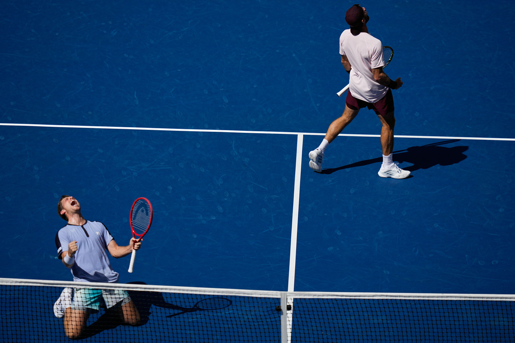 Neal Skupski, of Britain, bottom left, celebrates with Christian Harrison, of the United States, top right, after winning the men's doubles final of the U.S. Open tennis championships Kevin Krawietz, of Germany, and Tim Puetz, of Germany, Saturday, Sept. 12, 2026, in New York. (AP Photo/Frank Franklin II)