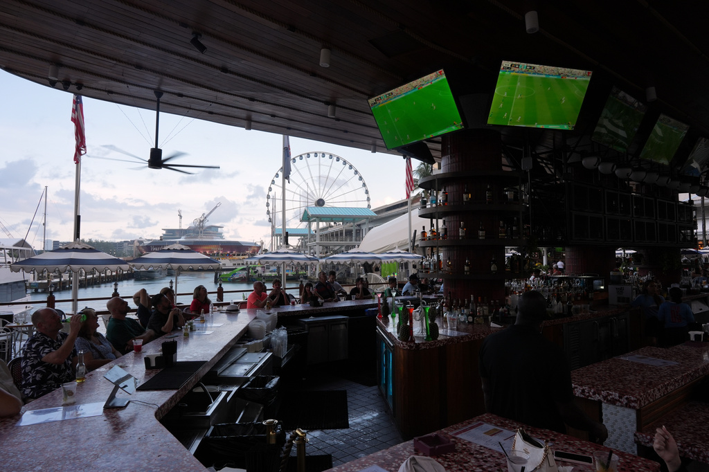 Soccer fans watch TV screens playing a World Cup round of 32 soccer match between Belgium and Senegal, at Bayside Marketplace in downtown Miami, Wednesday, July 1, 2026. (AP Photo/Rebecca Blackwell)