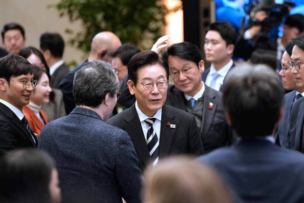 South Korean President Lee Jae Myung, center, leaves after a news conference to mark the first anniversary of the Dec. 3 martial law crisis at the Blue House in Seoul, South Korea, Wednesday, Dec. 3, 2025. (AP Photo/Ahn Young-joon)
