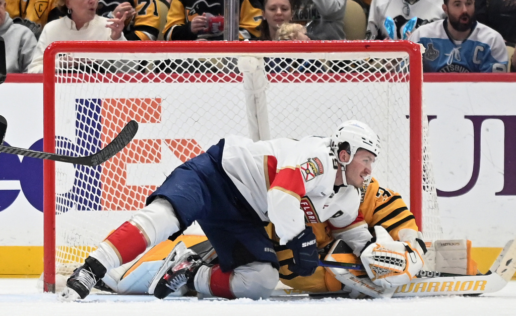 Florida Panthers left wing Matthew Tkachuk (19) wrestles away from Pittsburgh Penguins goalie Arturs Silovs (37) during the second period of an NHL hockey game, Sunday, April 5, 2026, in Pittsburgh. (AP Photo/Philip G. Pavely)