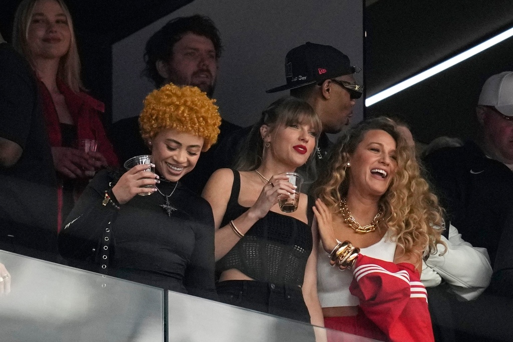 FILE - Taylor Swift, center, watches the teams before the NFL Super Bowl 58 football game between the San Francisco 49ers and the Kansas City Chiefs with Ice Spice, left, and Blake Lively, right, Feb. 11, 2024, in Las Vegas. (AP Photo/Ashley Landis, File
