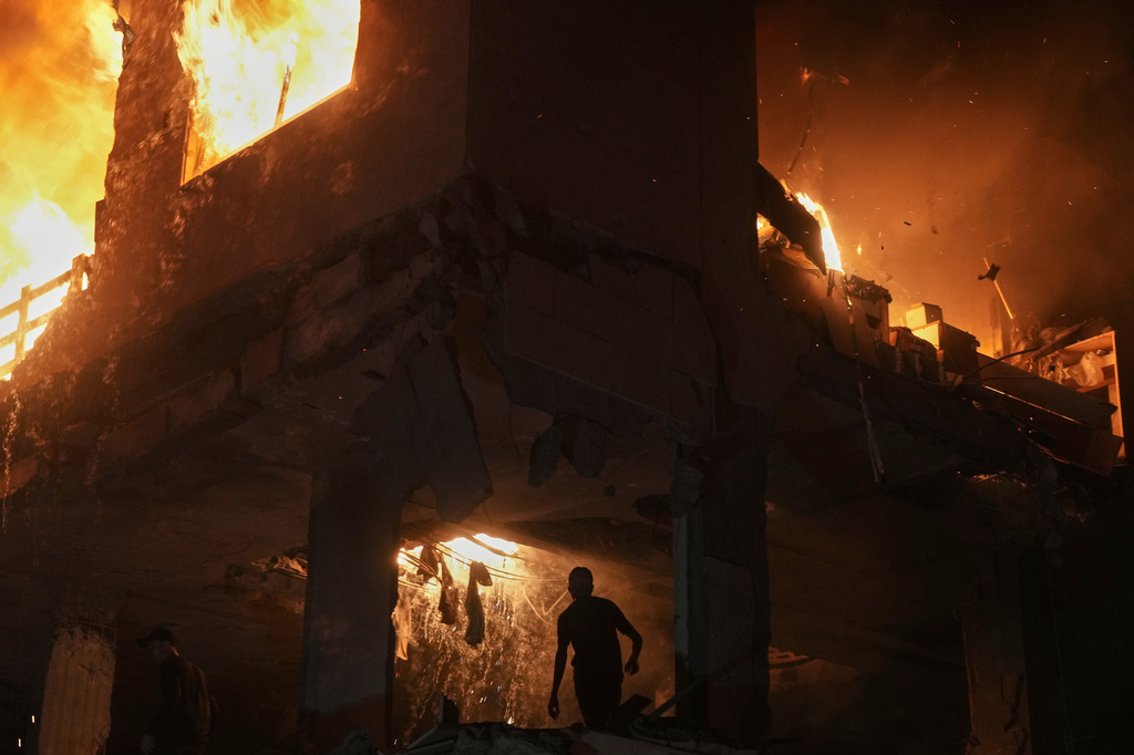 Palestinians react to a fire following an Israeli strike on a residential building in the Rimal neighborhood of Gaza City, Friday, May 15, 2026. (AP Photo/Jehad Alshrafi)