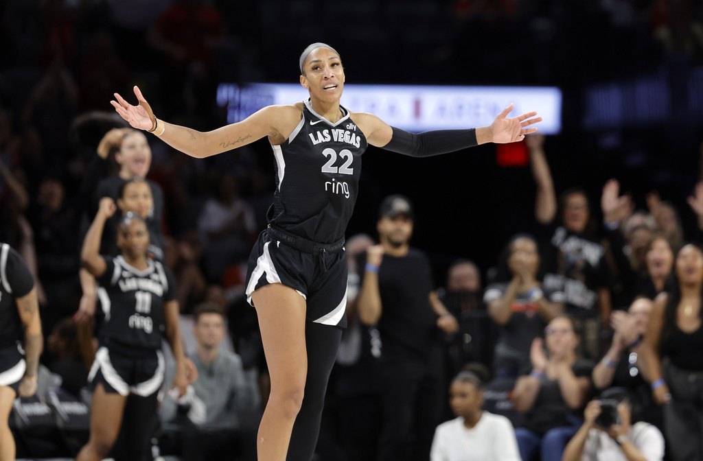 Las Vegas Aces center A'ja Wilson (22) celebrates after making a basket against the Atlanta Dream during the second half of a WNBA basketball game Tuesday, Aug. 19, 2025, in Las Vegas. (Steve Marcus/Las Vegas Sun via AP)