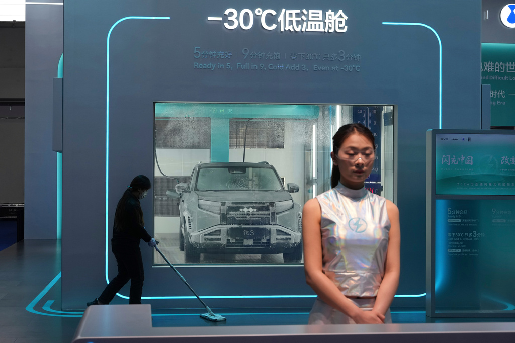A cleaner past by a chamber with sub-zero temperatures to showcase the battery charging technologies at the BYD booth during Auto China 2026 in Beijing, Friday, April 24, 2026. (AP Photo/Ng Han Guan)