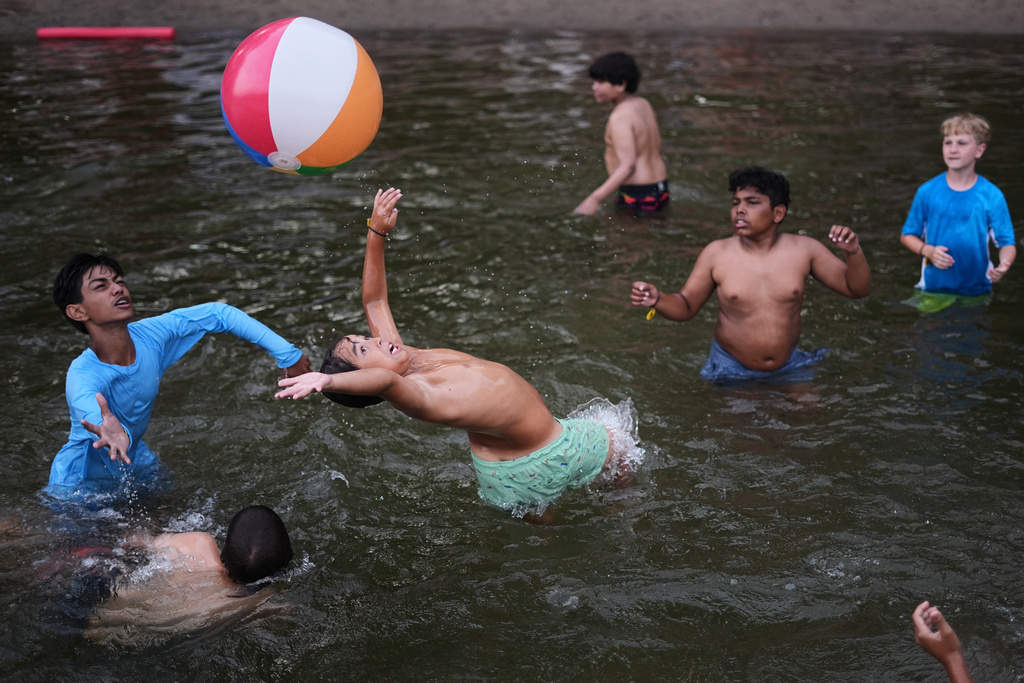 Nicholas Toska, 11, center, of Harrison, N.Y., who has juvenile idiopathic arthritis, reaches for a ball at the Frost Valley YMCA sleepaway camp in Claryville, N.Y., Wednesday, July 30, 2025. The camp partnered with Children's Hospital at Montefiore so kids with autoimmune diseases could attend for the first time. (AP Photo/Matt Rourke)