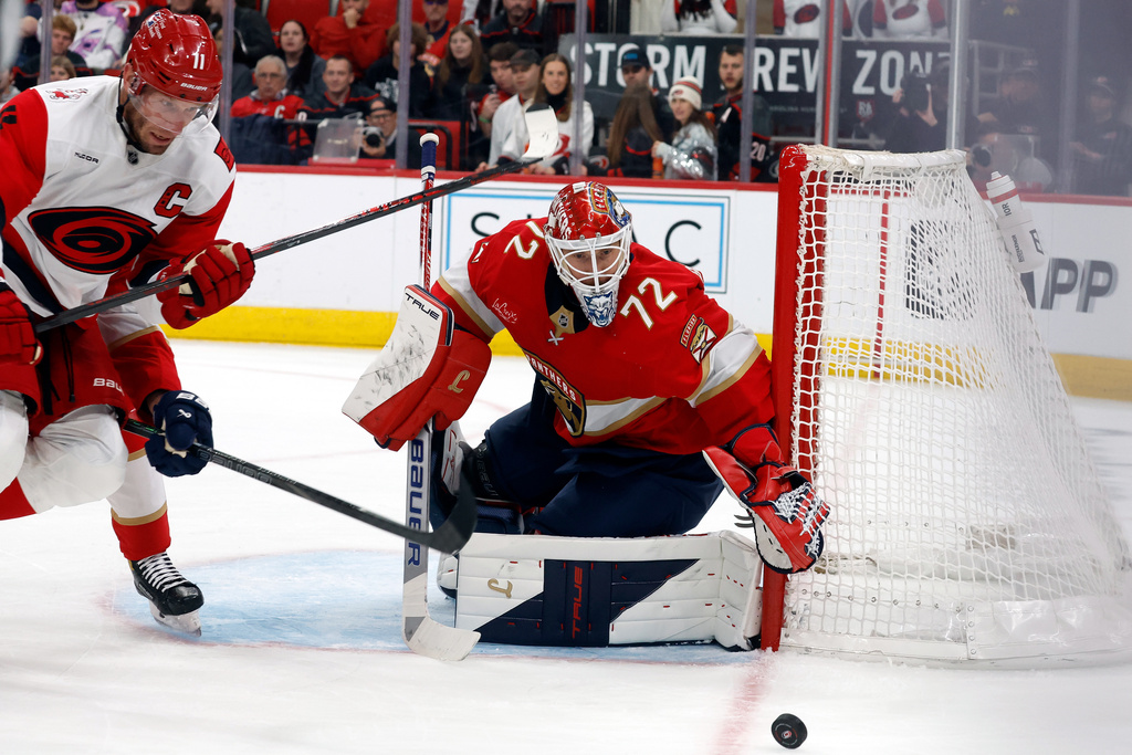 Florida Panthers goaltender Sergei Bobrovsky (72) watches the puck go by the net as Carolina Hurricanes' Jordan Staal (11) closes in during the second period of an NHL hockey game in Raleigh, N.C., Tuesday, Dec. 23, 2025. (AP Photo/Karl DeBlaker)