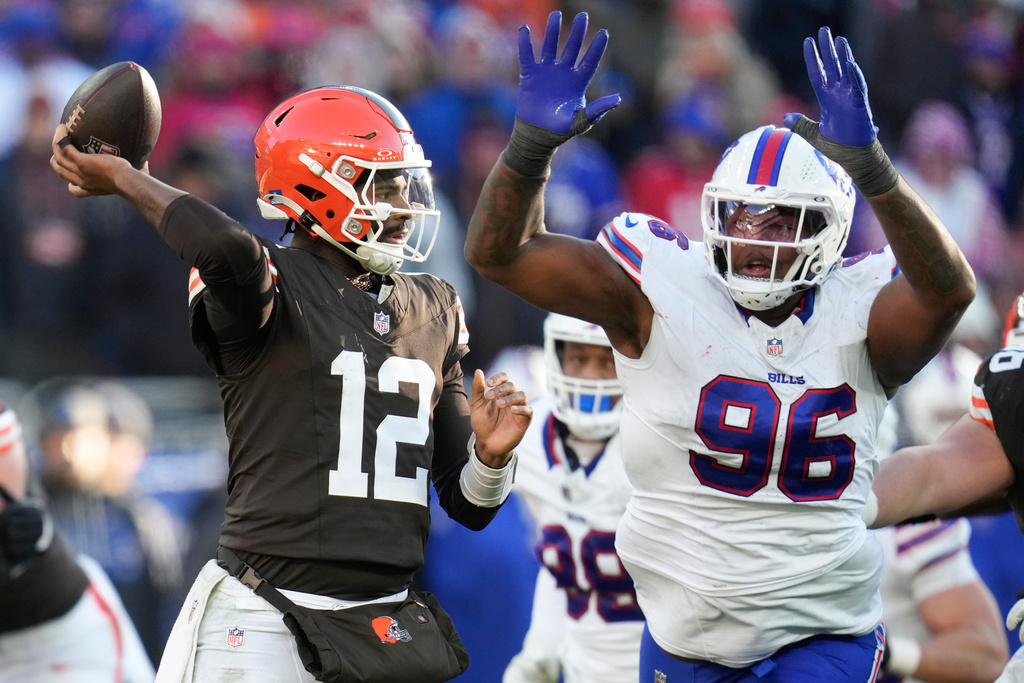 Cleveland Browns quarterback Shedeur Sanders (12) throws under pressure from Buffalo Bills defensive tackle Deone Walker (96) during the second half of an NFL football game in Cleveland, Sunday, Dec. 21, 2025. (AP Photo/Sue Ogrocki)