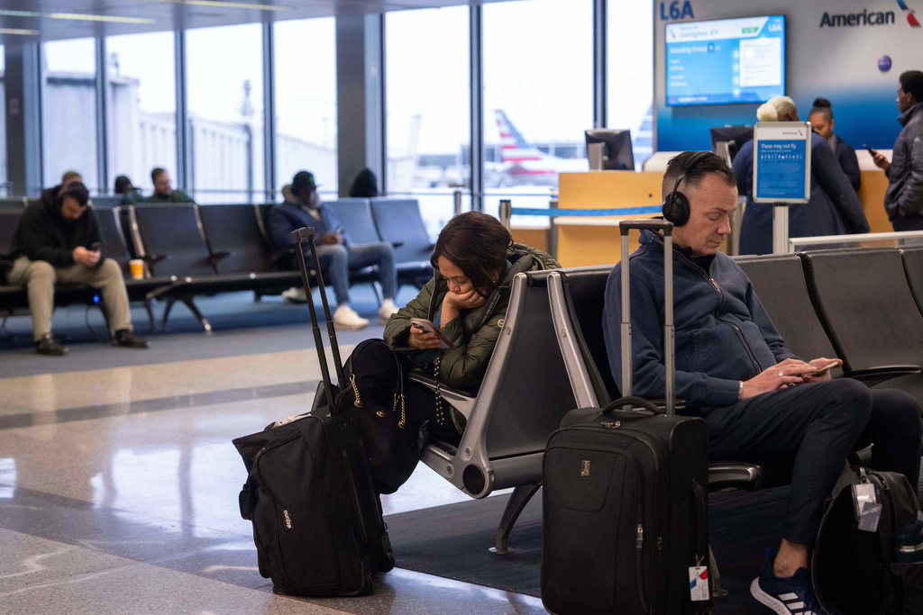 People wait for flights at Chicago O'Hare International Airport in Chicago, Ill., Sunday, Nov. 9, 2025. (AP Photo/Adam Gray)