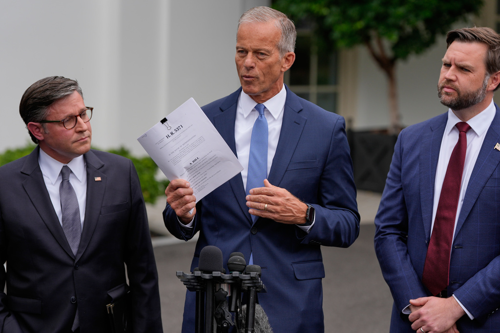 Senate Majority Leader John Thune, R-S.D., talks to reporters outside the West Wing of the White House, Monday, Sept. 29, 2025, in Washington, as House Speaker Mike Johnson of La., and Vice President JD Vance, listen. (AP Photo/Alex Brandon)