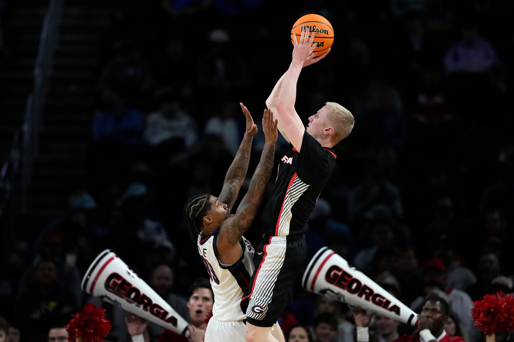 FILE - Georgia guard Blue Cain, right, shoots over Gonzaga guard Khalif Battle during the second half of the first round of the NCAA college basketball tournament, March 20, 2025, in Wichita, Kan. (AP Photo/Charlie Riedel, File)