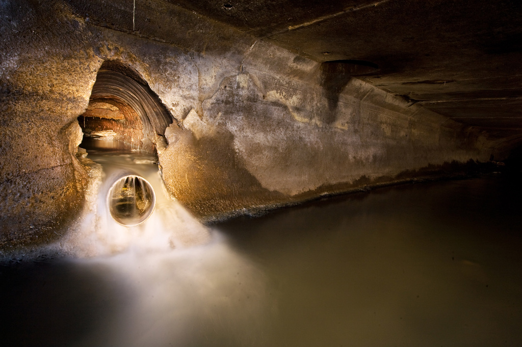 This 2008 photo provided. by Steve Duncan, water flows through a sewer tunnel in the borough of Manhattan in New York. (Steve Duncan via AP)