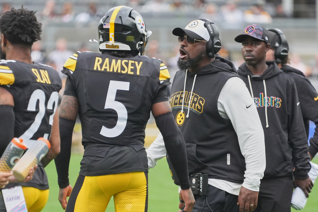Pittsburgh Steelers head coach Mike Tomlin, right, talks with cornerback Jalen Ramsey (5) in the first half of an NFL football game against the Cleveland Browns in Pittsburgh, Sunday, Oct. 12, 2025. (AP Photo/Gene J. Puskar)