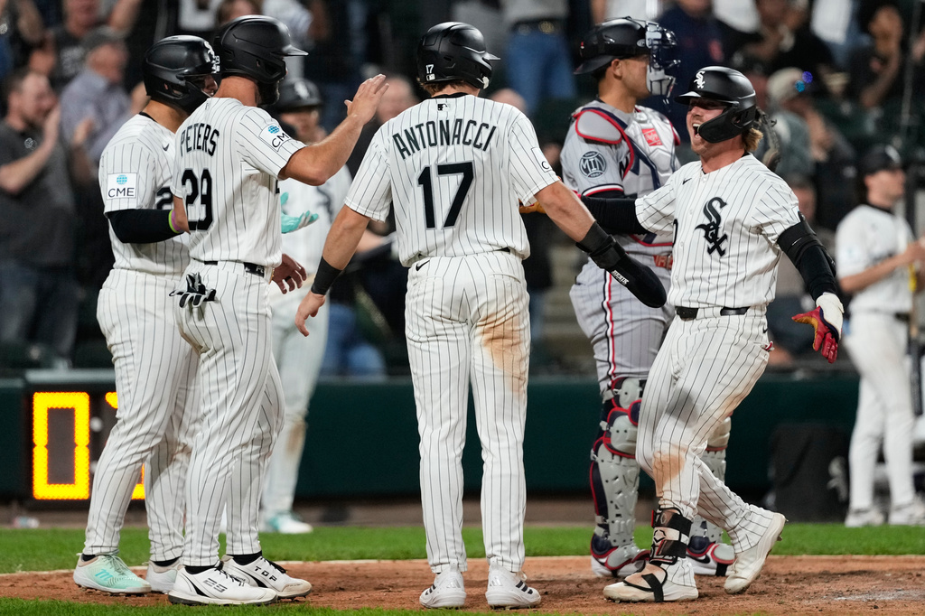 Chicago White Sox's Chase Meidroth, right, celebrates with Edgar Quero, left, Tristan Peters (29) and Sam Antonacci (17) after hitting a grand slam during the seventh inning of a baseball game against the Minnesota Twins in Chicago, Wednesday, May 27, 2026. (AP Photo/Nam Y. Huh)