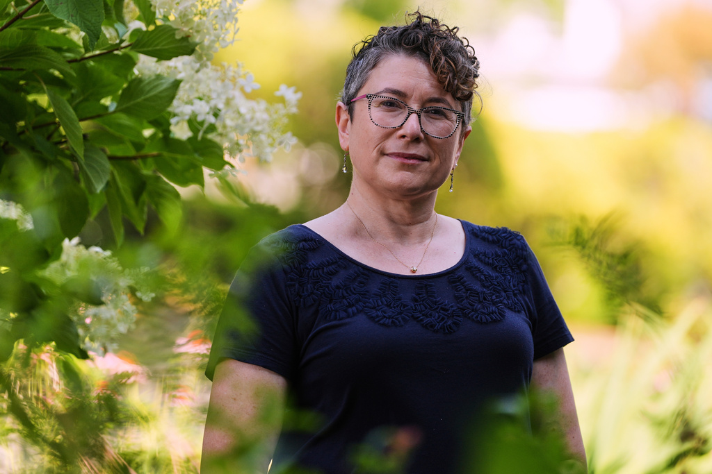 Ziva Mann, mother of a transgender child and member of a welcoming synagogue, poses in her garden, Wednesday, Aug. 13, 2025, in Newton, Mass. (AP Photo/Charles Krupa)