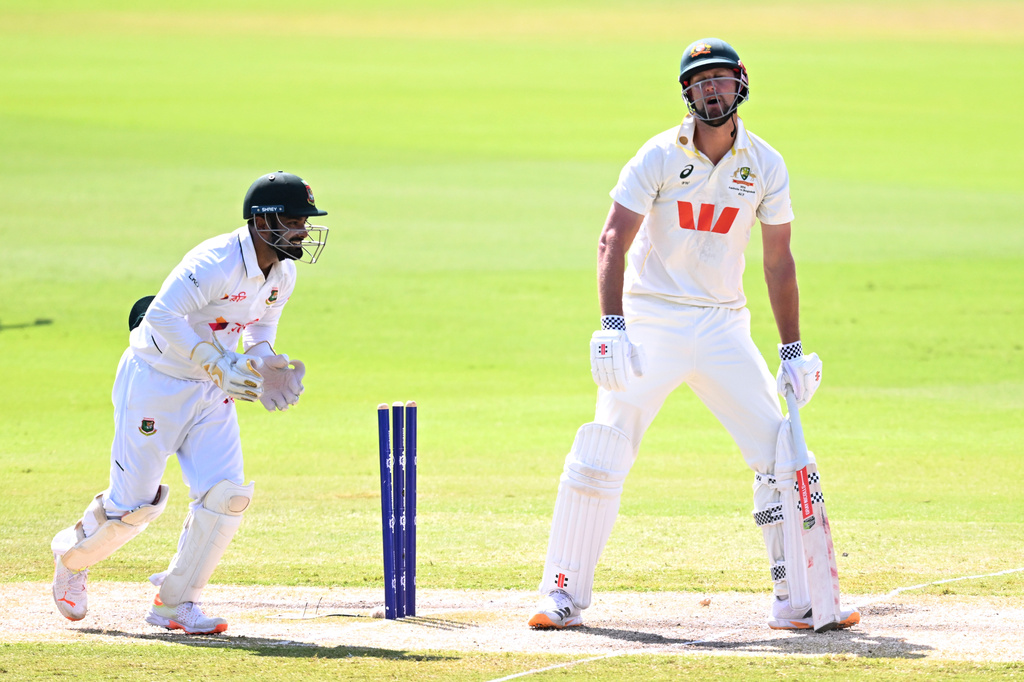 Beau Webster, right, of Australia reacts after being dismissed by Mehidy Hasan Miraz of Bangladesh during play on day four of the first cricket test in Darwin, Australia, Sunday, Aug. 16, 2026. (James Ross/AAP Image via AP)