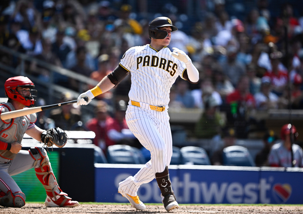 San Diego Padres' Gavin Sheets hits an RBI double during the eighth inning of a baseball game against the Cincinnati Reds, Wednesday, June 10, 2026, in San Diego. (AP Photo/Denis Poroy)