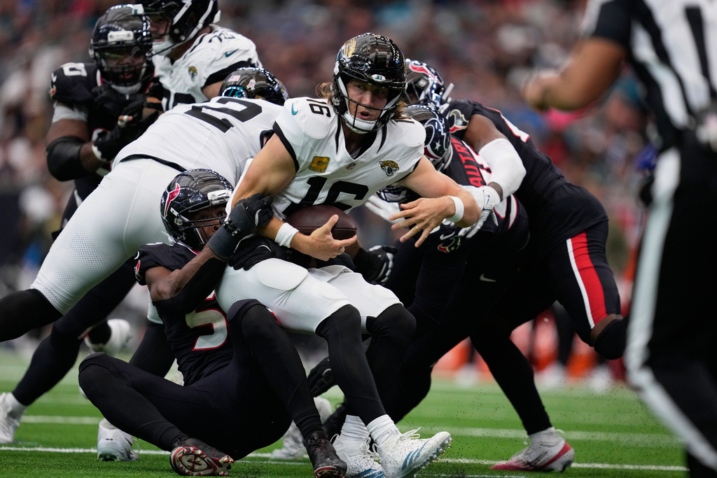 Houston Texans defensive end Danielle Hunter (55) sacks Jacksonville Jaguars quarterback Trevor Lawrence (16) during the second half of an NFL football game, Sunday, Nov. 9, 2025, in Houston. (AP Photo/Ashley Landis)