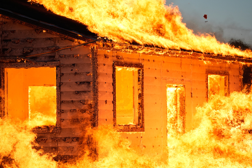 An accessory dwelling unit burns during an experiment at the Institute for Business & Home Safety center on Thursday, April 16, 2026, in Richburg, S.C. (AP Photo/Erik Verduzco)