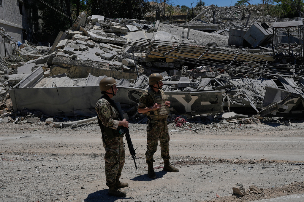 Lebanese army soldiers stand in front of a house that was destroyed in the recent clashes between Hezbollah fighters and Israeli troops in Dibbine village, southeast Lebanon, Friday, June 5, 2026, a day after Israeli forces withdrew. (AP Photo/Hussein Malla)