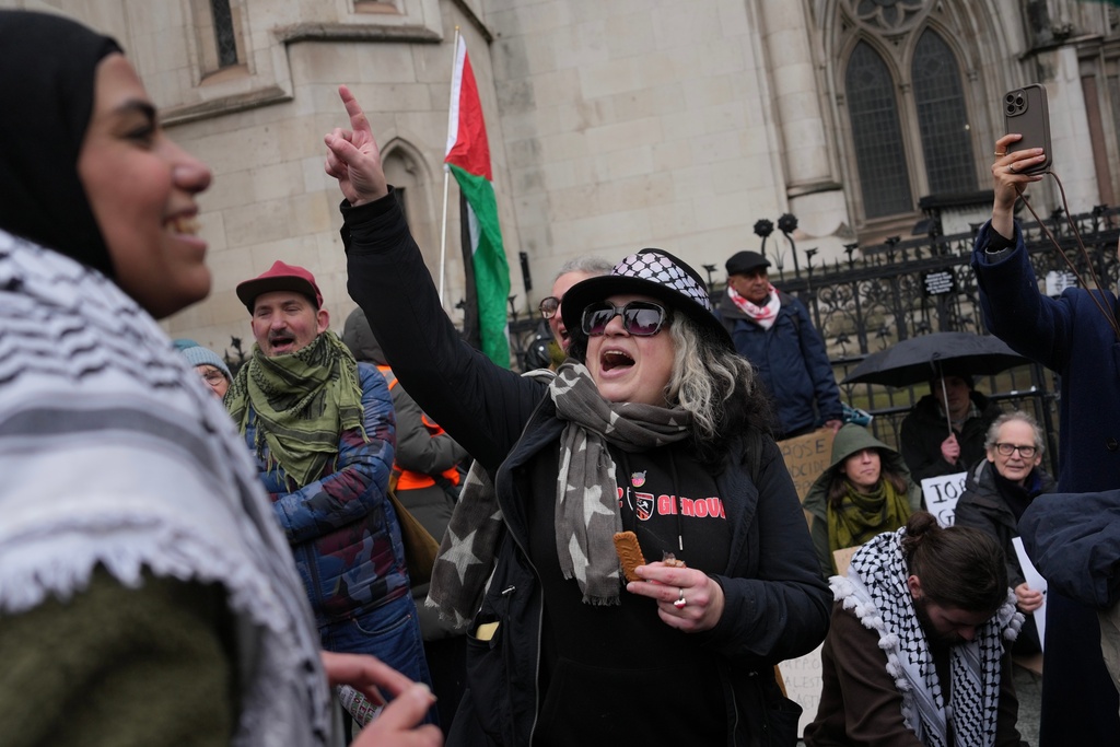 Supporters of Palestine Action stage a protest outside the Royal Court of Justice in London, Friday, Feb. 13, 2026. (AP Photo/Kin Cheung)