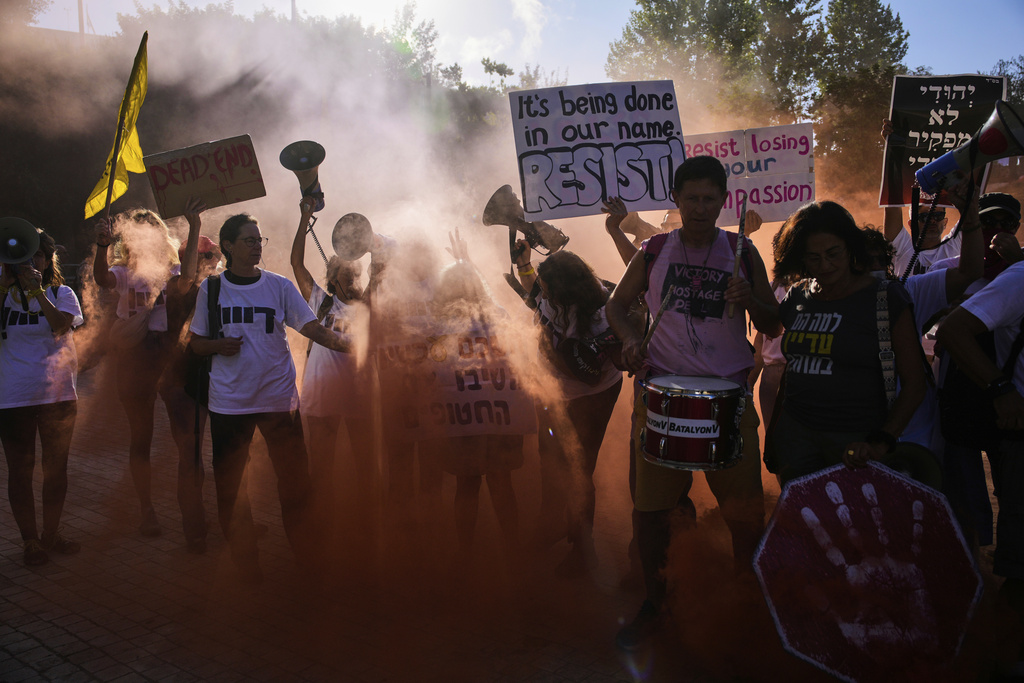 Demonstrators wave signs and shout slogans during a protest demanding the immediate release of all hostages held by Hamas and calling for the end of the war in the Gaza Strip, in Jerusalem, Wednesday, Sept. 3, 2025. (AP Photo/Ohad Zwigenberg)