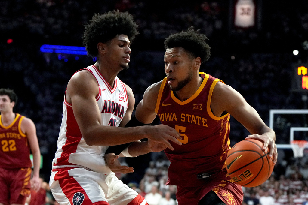 Iowa State forward Joshua Jefferson (5) drives on Arizona forward Koa Peat during the first half of an NCAA college basketball game, Monday, March 2, 2026, in Tucson, Ariz. (AP Photo/Rick Scuteri)
