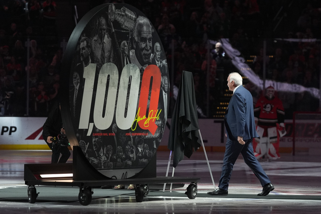 Anaheim Ducks head coach Joel Quenneville walks onto the ice to be honored for his 1,000th career coaching victory before an NHL hockey game against the Calgary Flames Sunday, March 1, 2026, in Anaheim, Calif. (AP Photo/Gregory Bull)