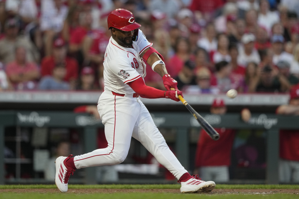 Cincinnati Reds' Miguel Andujar hits a grand slam home run during the seventh inning of a baseball game against the Philadelphia Phillies Wednesday, Aug. 13, 2025, in Cincinnati. (AP Photo/Carolyn Kaster)