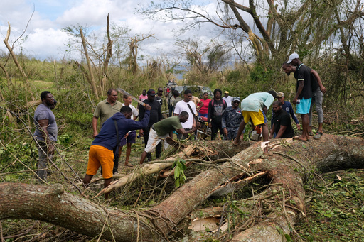 Men clear a blocked road in the aftermath of Hurricane Melissa in Santa Cruz, Jamaica, Wednesday, Oct. 29, 2025. (AP Photo/Matias Delacroix) Men clear a blocked road in the aftermath of Hurricane Melissa in Santa Cruz, Jamaica, Wednesday, Oct. 29, 2025. (AP Photo/Matias Delacroix)