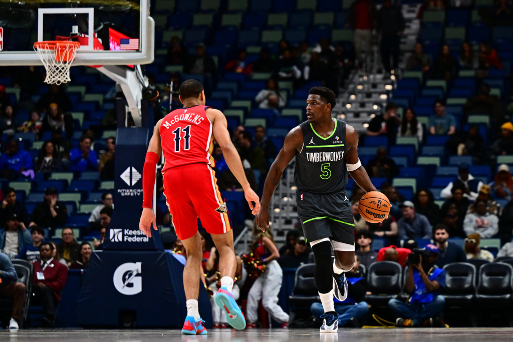 Minnesota Timberwolves guard Anthony Edwards (5) drives with the ball against New Orleans Pelicans guard Bryce McGowens (11) in the first half of an NBA basketball game in New Orleans, Thursday, Dec. 4, 2025. (AP Photo/Ella Hall)
