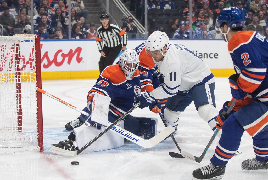 Toronto Maple Leafs' Max Domi (11) is stopped by Edmonton Oilers' goalie Connor Ingram (39) during first period NHL action, in Edmonton on Tuesday, Feb. 3, 2026. (Jason Franson/The Canadian Press via AP)