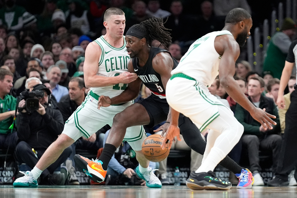 Portland Trail Blazers guard Jrue Holiday (5) drives to the basket against Boston Celtics guard Payton Pritchard (11) during the first half of an NBA basketball game Monday, Jan. 26, 2026, in Boston. (AP Photo/Robert F. Bukaty)