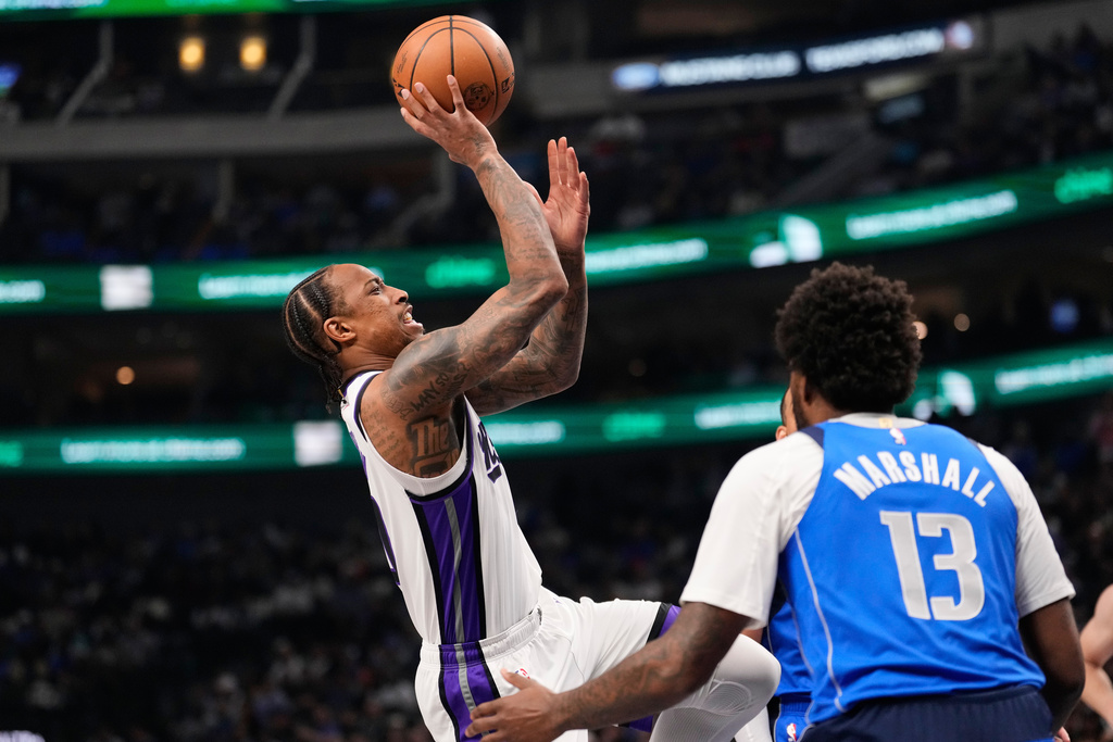 Sacramento Kings guard DeMar DeRozan (10) shoots as Dallas Mavericks' Naji Marshall (13) defends in the first half of an NBA basketball game in Dallas, Thursday, Feb. 26, 2026. (AP Photo/Tony Gutierrez)