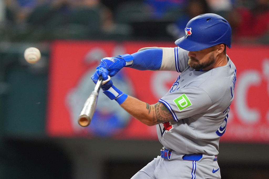 Toronto Blue Jays' Nathan Lukes hits a sacrifice flyout which scored teammate Brett Bateman during the first inning of a baseball game against the Texas Rangers, Sunday, Sept. 20, 2026, in Arlington, Texas. (AP Photo/LM Otero)