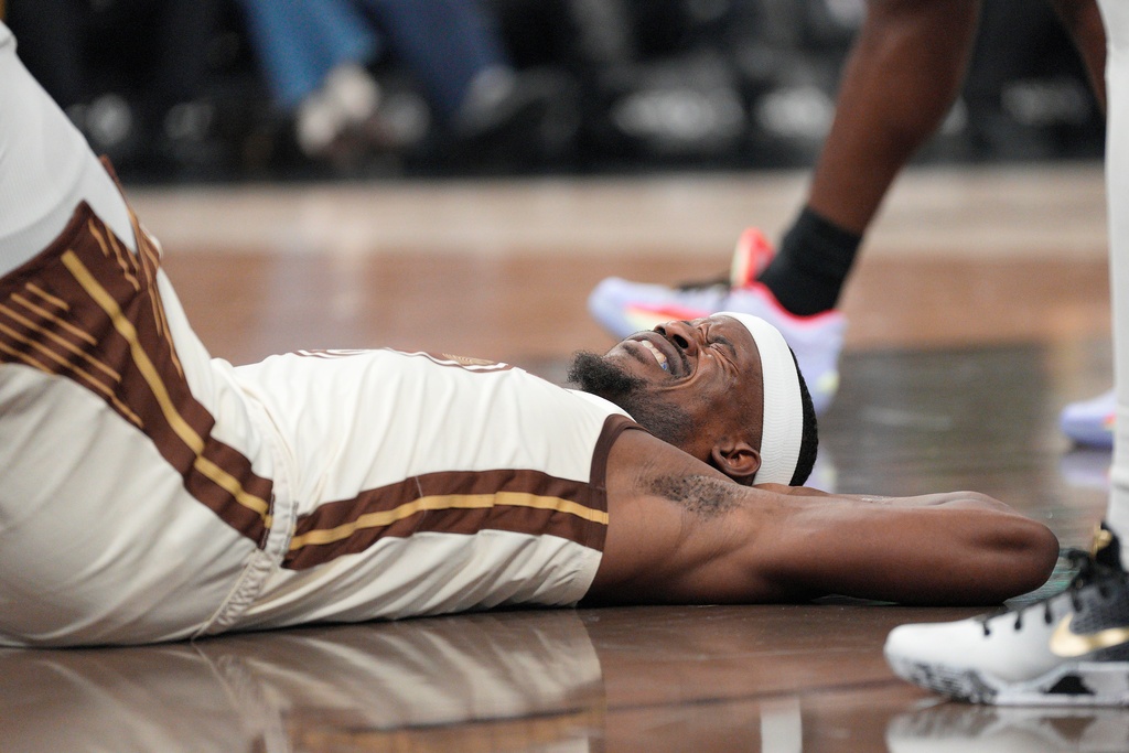 Golden State Warriors forward Jimmy Butler III lies on the floor after being fouled during the first half of an NBA basketball game against New Orleans Pelicans in San Francisco, Saturday, Nov. 29, 2025. (AP Photo/Tony Avelar)