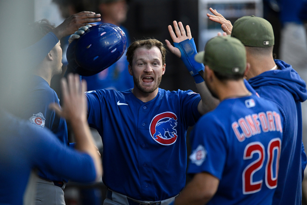 Chicago Cubs' Ian Happ celebrates with teammates in the dugout after scoring on a Carson Kelly single during the fourth inning of a baseball game against the Chicago White Sox in Chicago, Friday, May 15, 2026. (AP Photo/Paul Beaty)