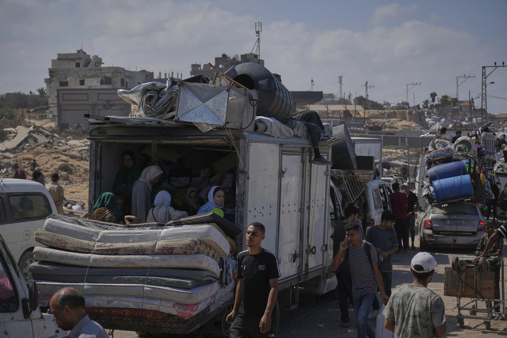 Displaced Palestinians flee northern Gaza along the coastal road toward the south, as Israel announced an expanded operation in Gaza City, Tuesday, Sept. 16, 2025. (AP Photo/Abdel Kareem Hana)