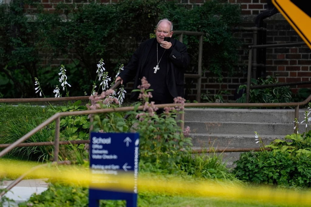 FILE - The archbishop of Saint Paul and Minneapolis, Bernard Hebda talks on the phone outside the Annunciation Church's school after shooting, Wednesday, Aug. 27, 2025, in Minneapolis. (AP Photo/Abbie Parr, File)