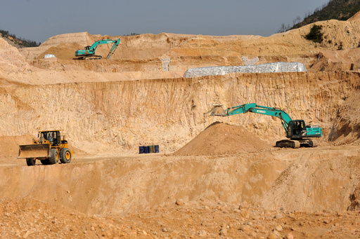 FILE - Workers use machinery to dig at a rare earth mine in Ganxian county in central China's Jiangxi province on Dec. 30, 2010. (Chinatopix via AP, File) FILE - Workers use machinery to dig at a rare earth mine in Ganxian county in central China's Jiangxi province on Dec. 30, 2010. (Chinatopix via AP, File)