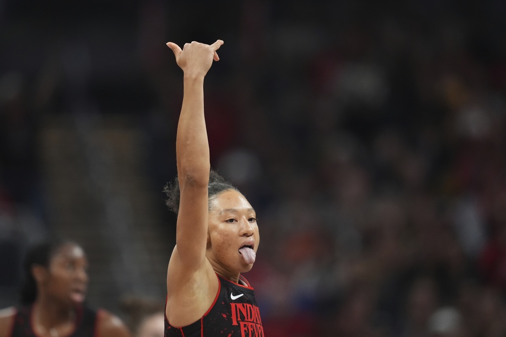 Indiana Fever's Aerial Powers reacts after hitting a 3-point shot during the first half of a WNBA basketball game against the Minnesota Lynx, Tuesday, Sept. 9, 2025, in Indianapolis. (AP Photo/Darron Cummings)
