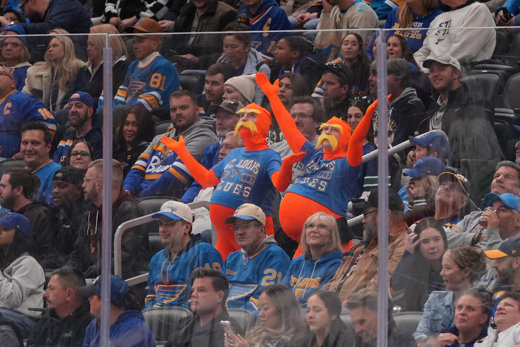 Fans are dressed in costumes for Halloween during the first period of an NHL hockey game between the St. Louis Blues and the Vancouver Canucks Thursday, Oct. 30, 2025, in St. Louis. (AP Photo/Jeff Roberson)
